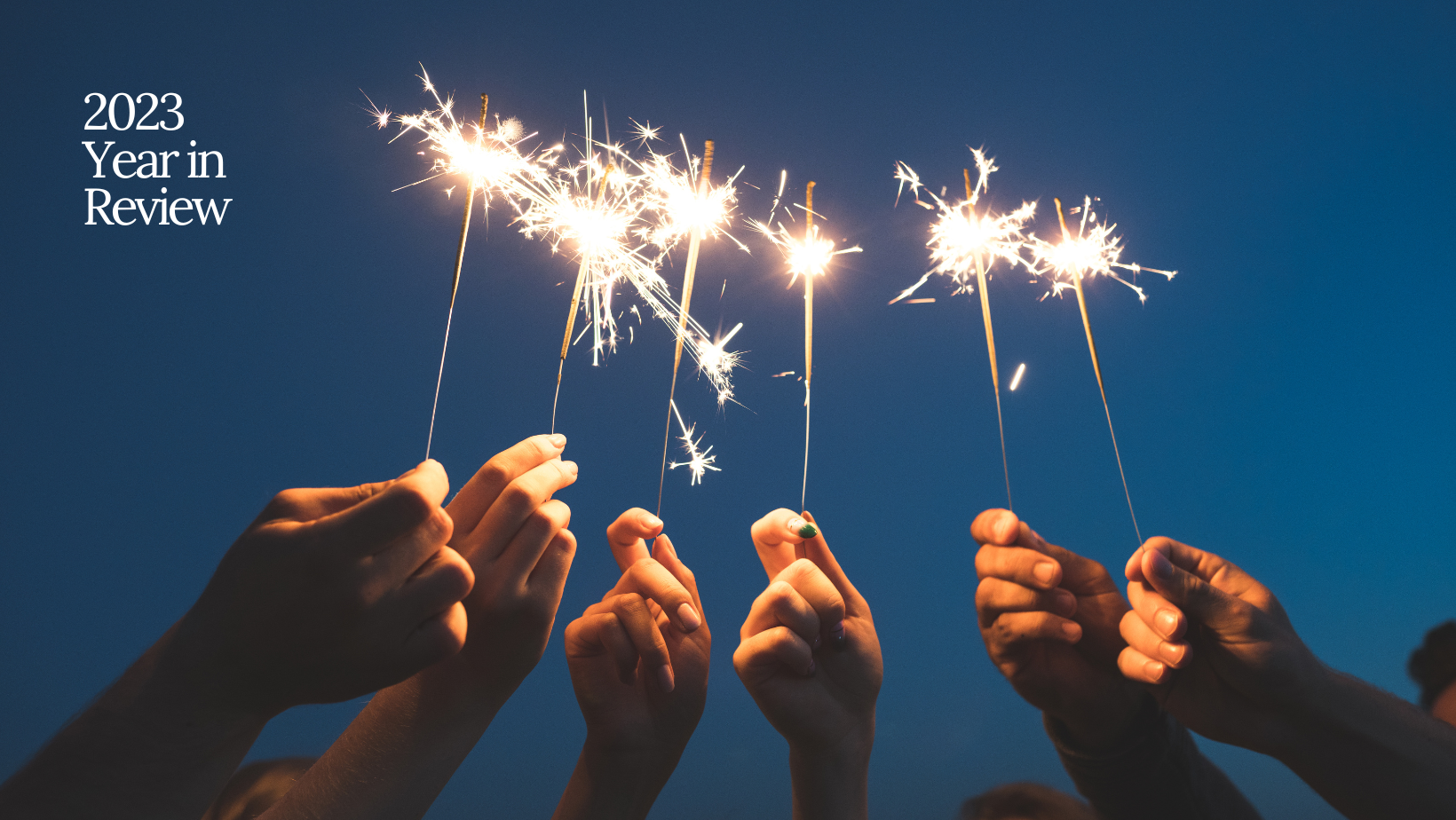 six hands holding sparklers