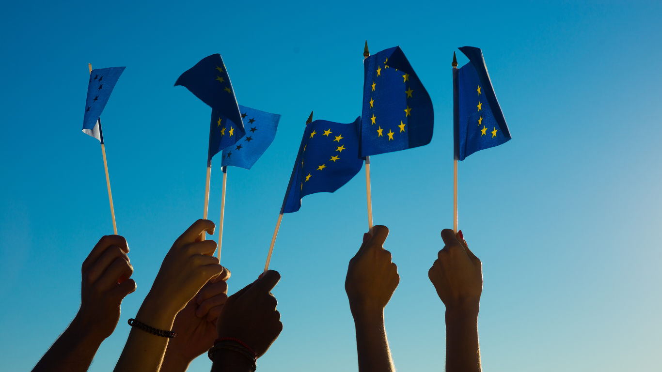 Multiple hands waving the European Union flags