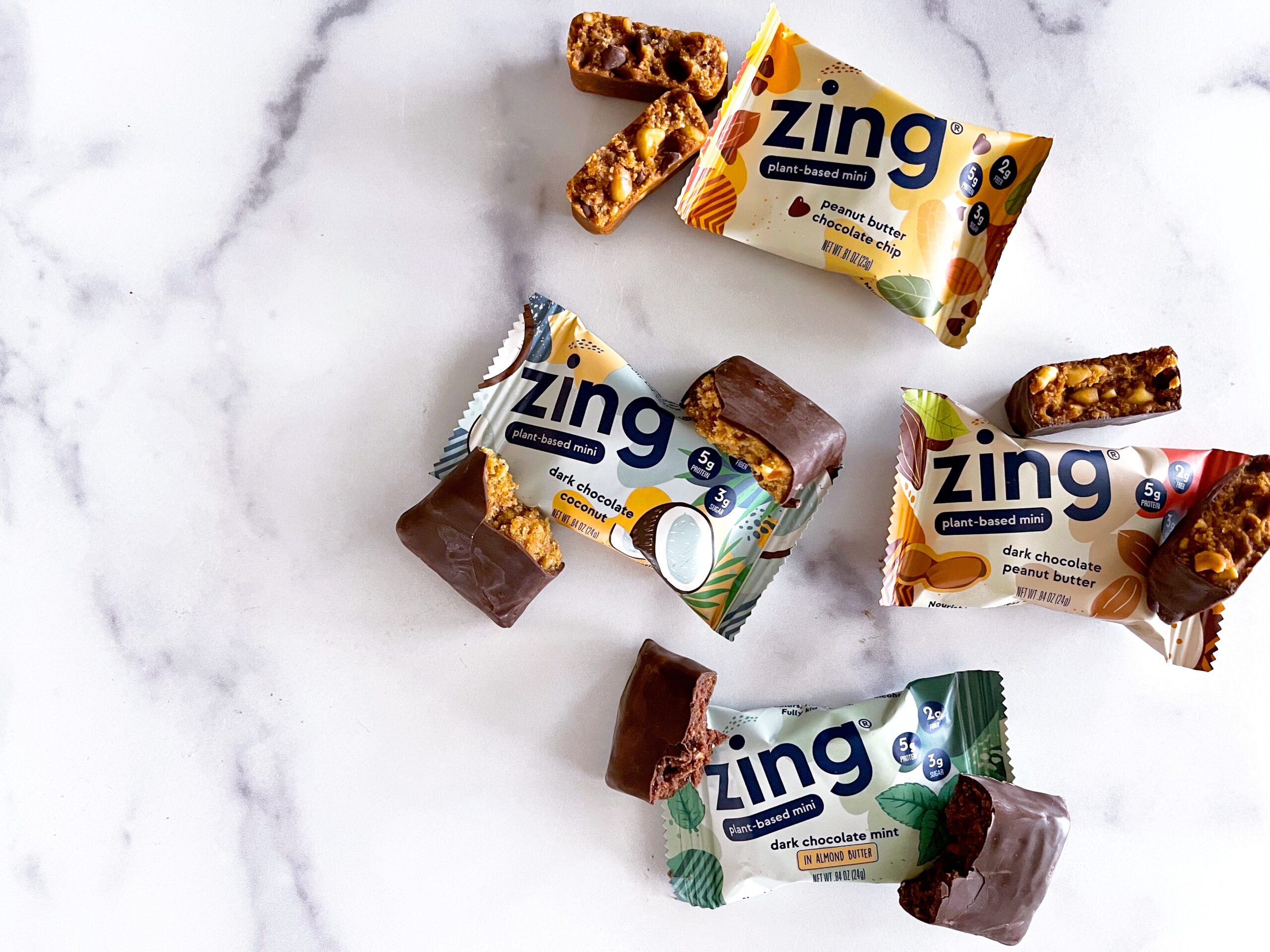 four different flavored Zing bars broken into two halves