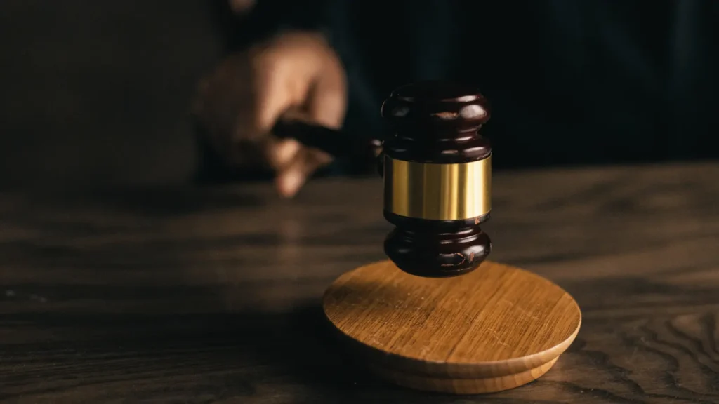 Judge's gavel resting on a polished wooden table