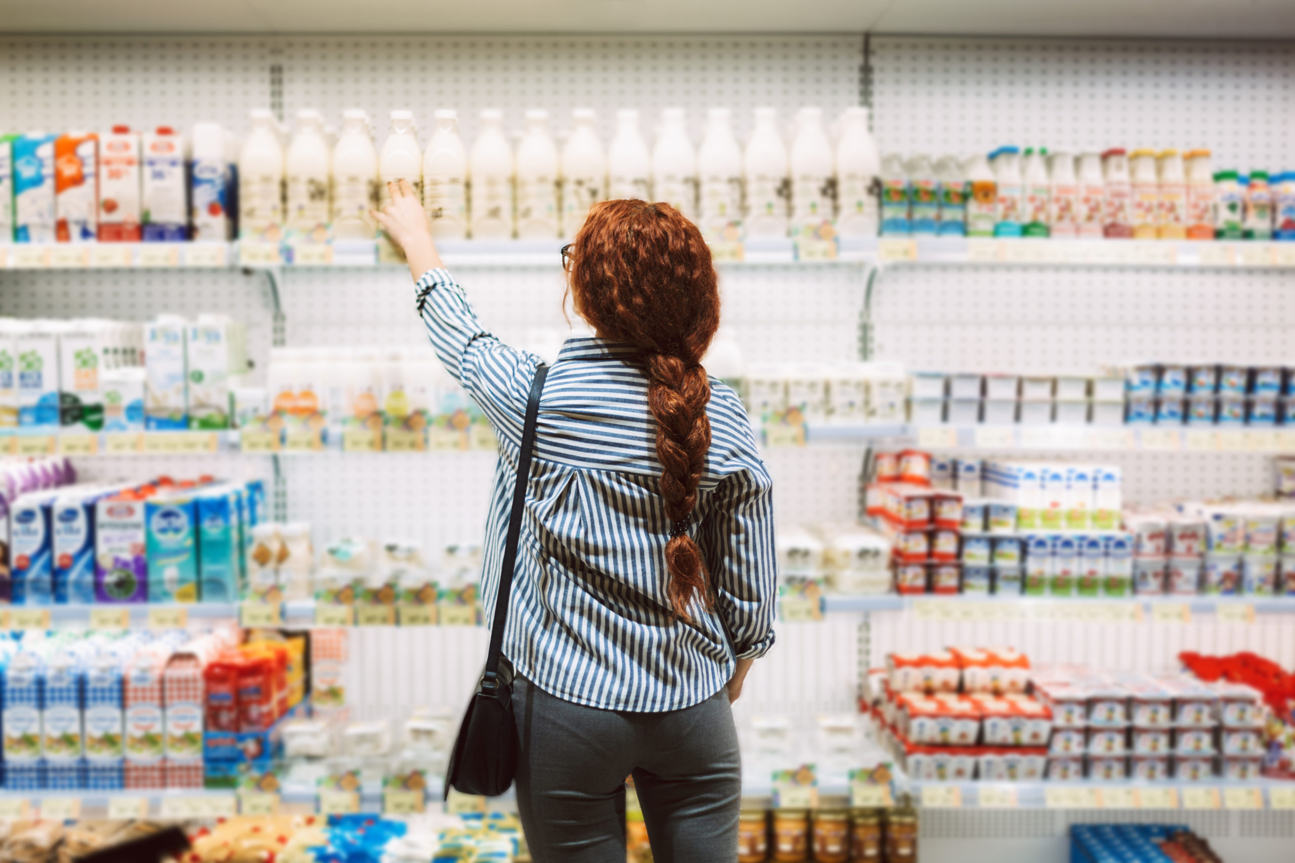 lady standing in front of the dairy aisle