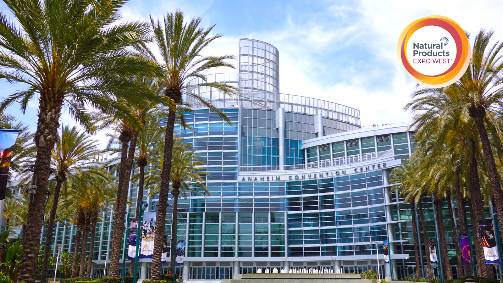 Front view of Anaheim Convention Center with palm trees on both sides