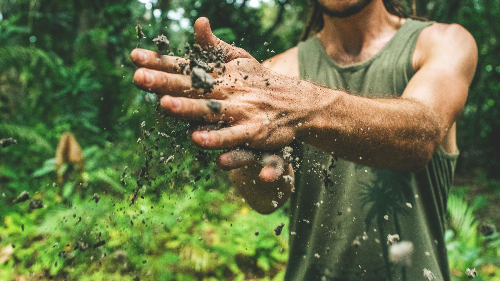 Man rubbing off soil from hands