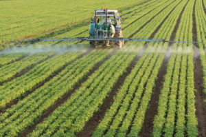 Farmer spraying a field