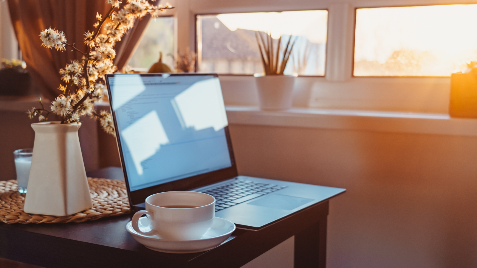 laptop and a coffee cup sitting on a table